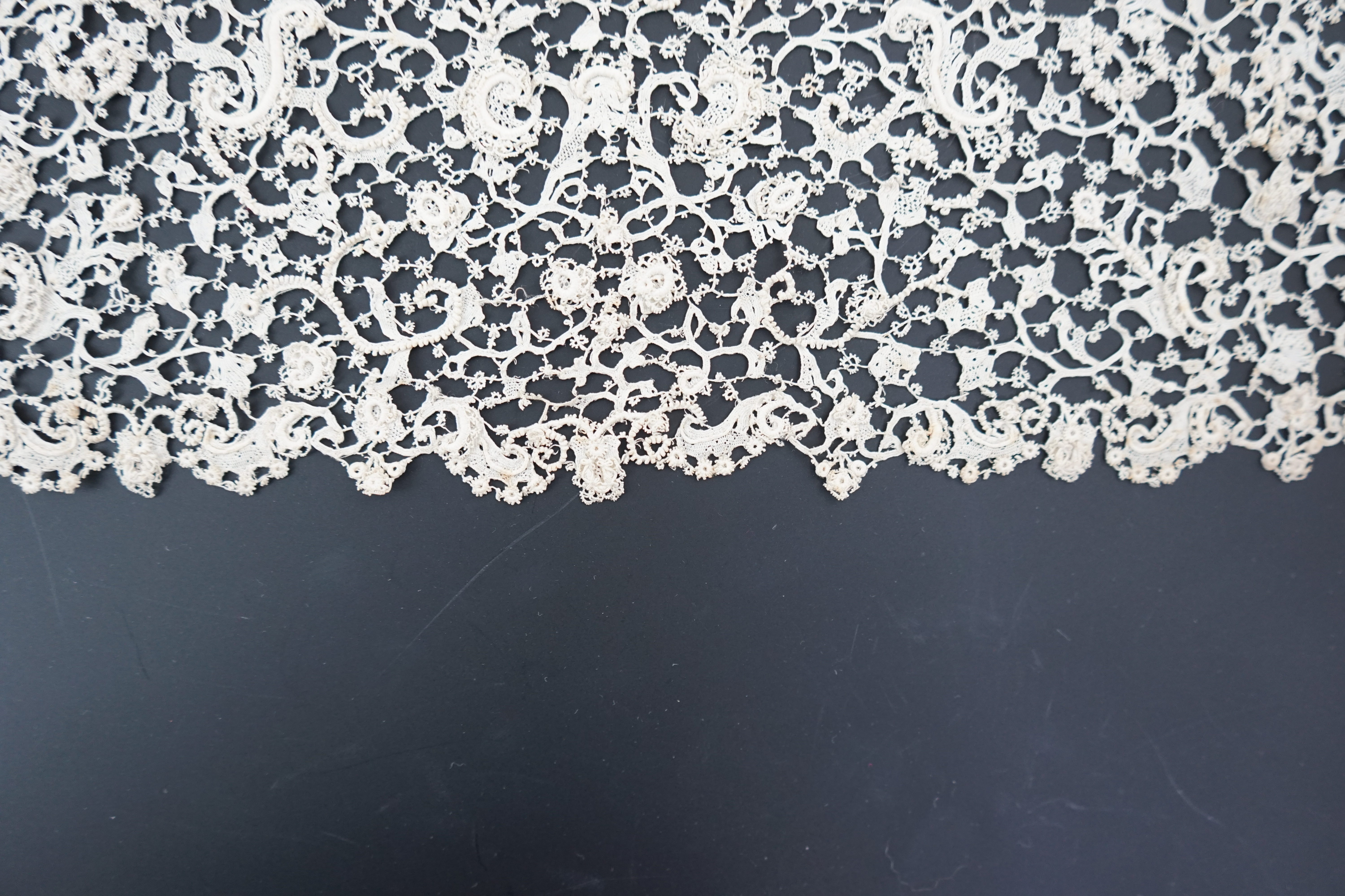 A rare 1680 (360cm length x 28cm deep) flounce of Point de neige, being an elaborate finely raised Venetian needle-point lace, a scaled down version of gros point, this flounce worked into tiny floral and leaf shapes, jo